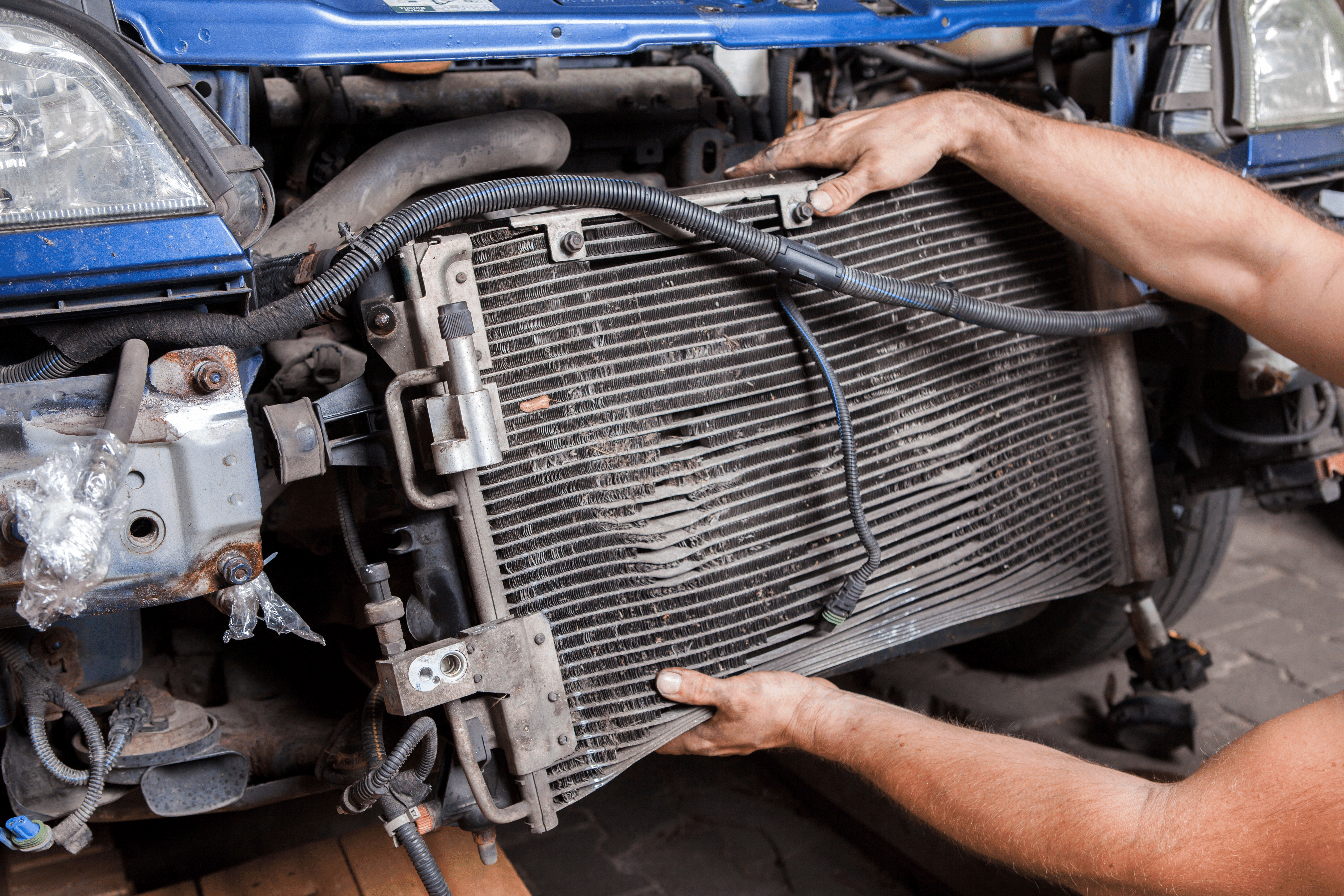 Disassembly of an old and worn car radiator by a mechanic, Understanding how the cooling system works will help you to maintain it for peak performance and increase your cars fuel efficiency.