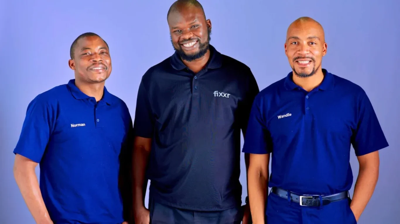 3 Fixxr mechanics standing side by side smiling in Fixxr golf shirts